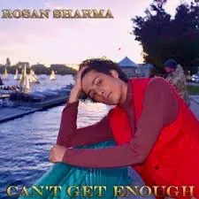 Can't Get Enough cover art: Rosan Sharma by the water at dusk